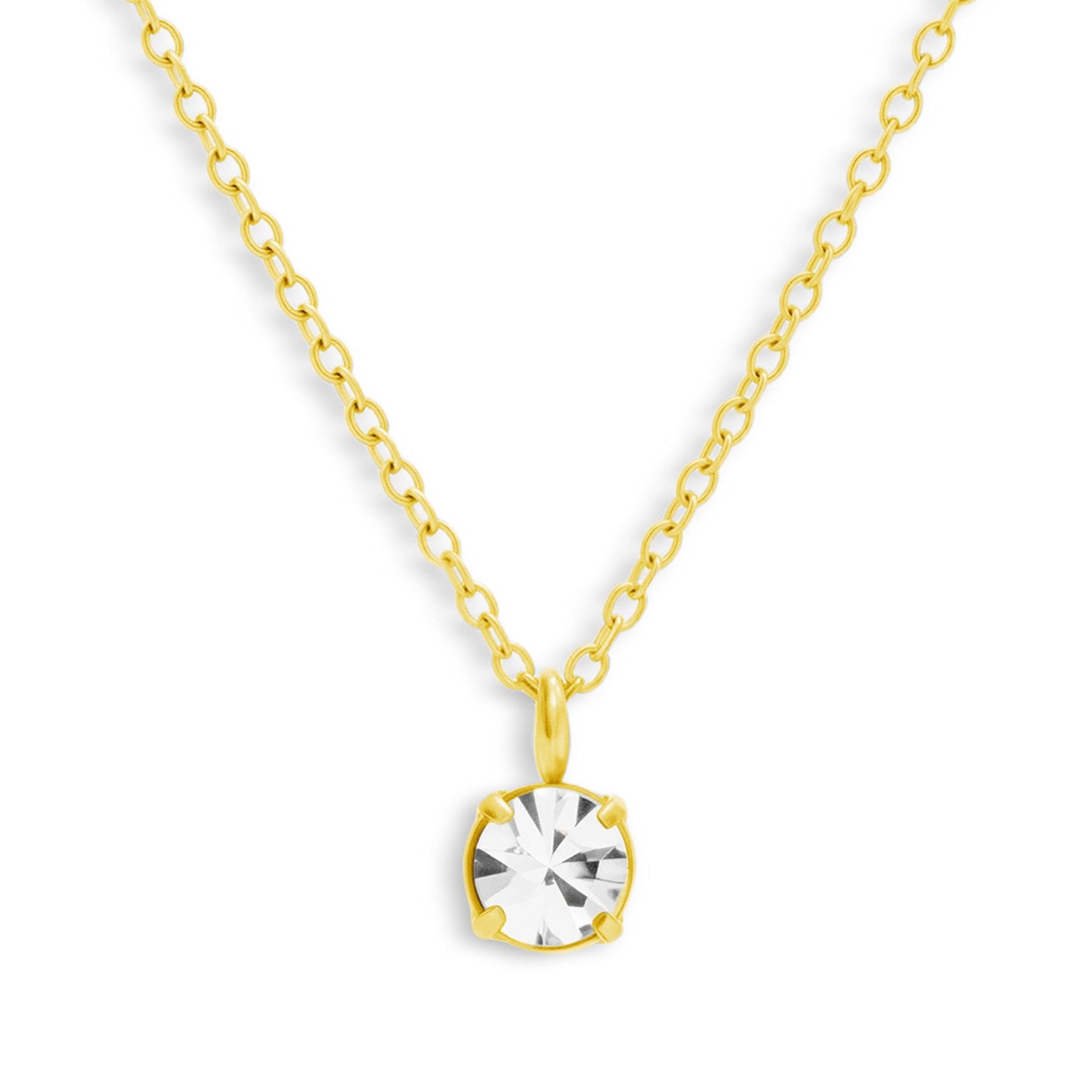 Gold tone chain necklace with a single round clear stone solitaire pendant on a white background