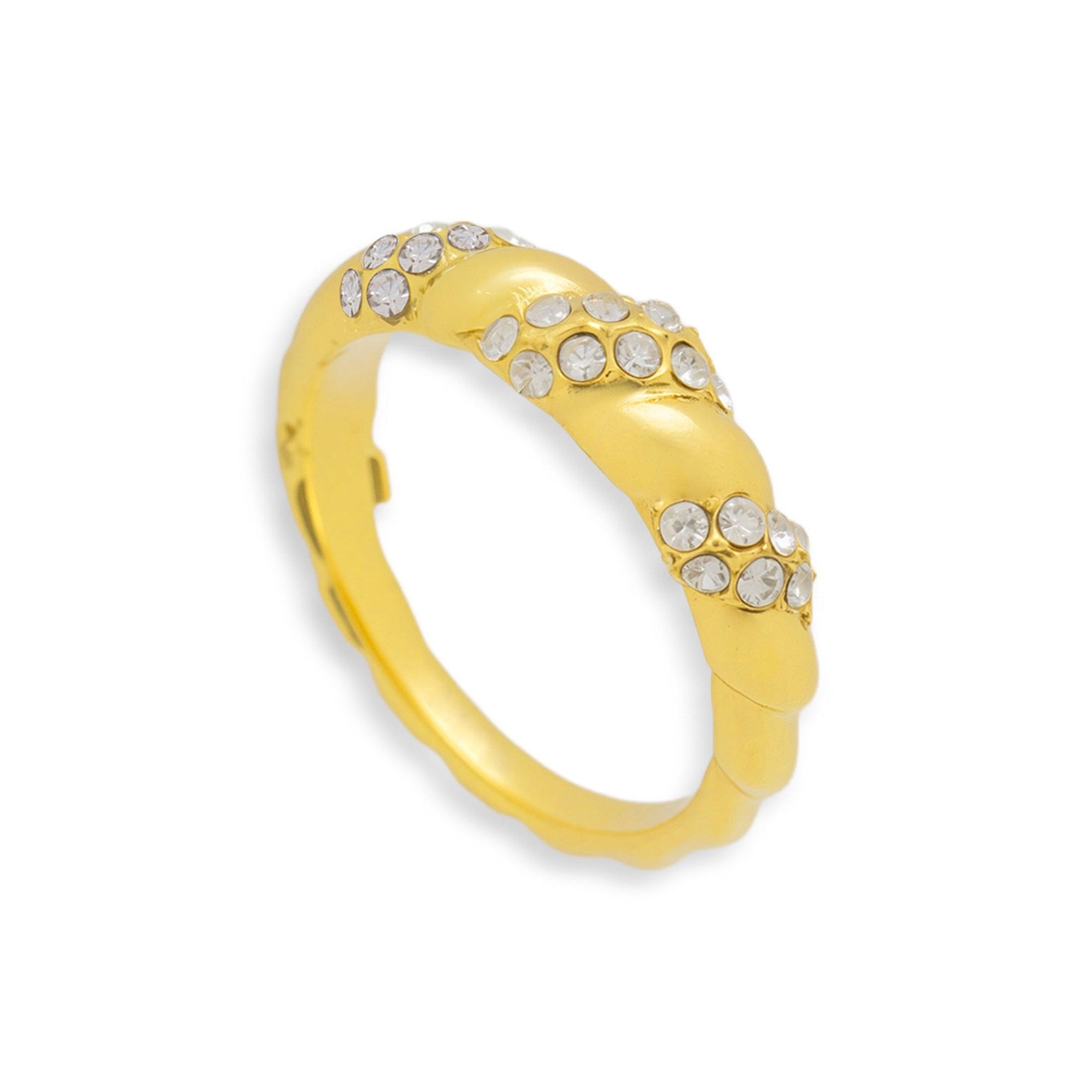 Gold tone twisted dome ring set with small clear stones on a white background