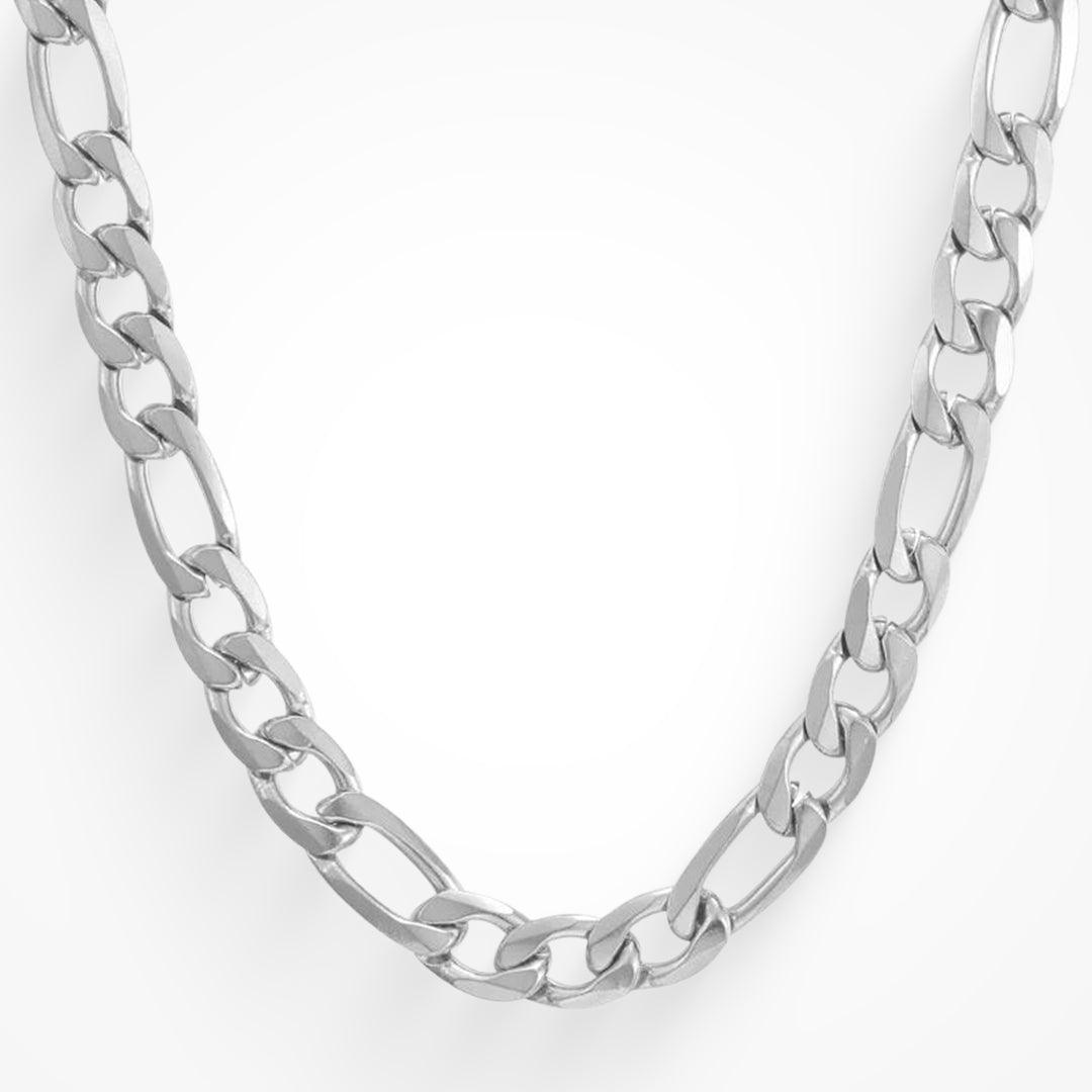 Chunky silver colored figaro link chain necklace laid out on a white background