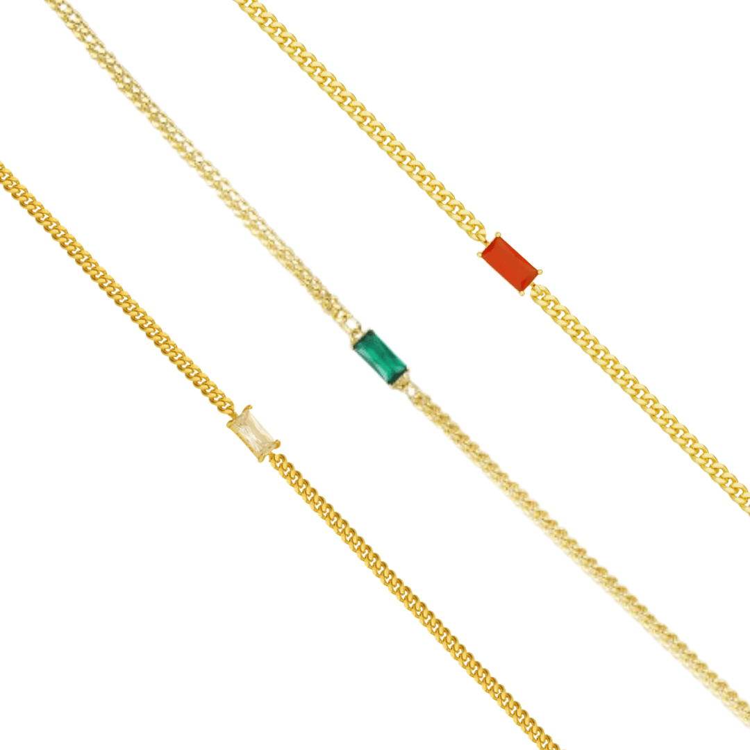Three gold tone chain bracelets, each set with a small rectangular stone in red, green or clear