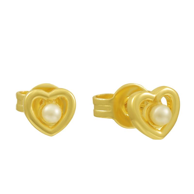 Gold heart stud earrings with pearl centers on white