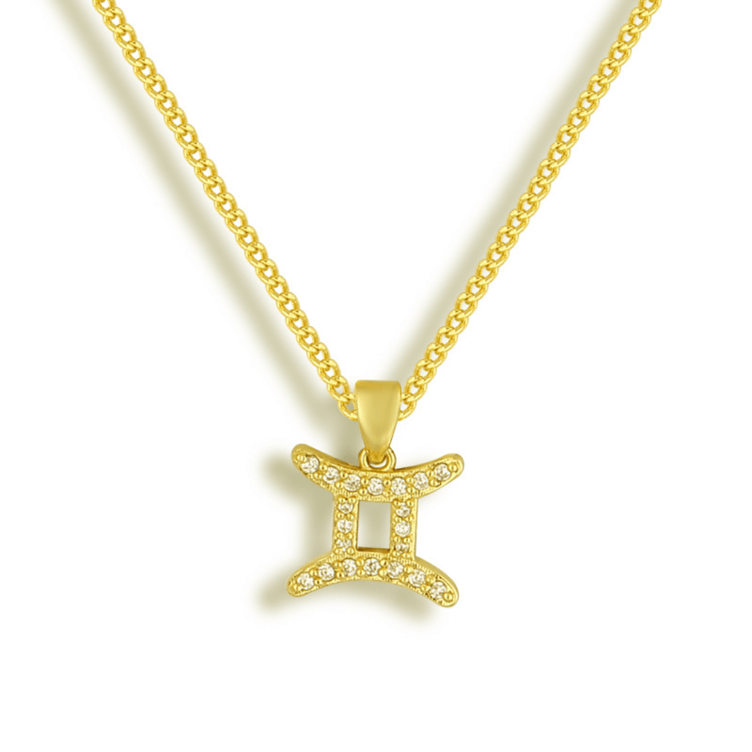 Gold tone necklace with a Gemini zodiac symbol pendant set with clear stones