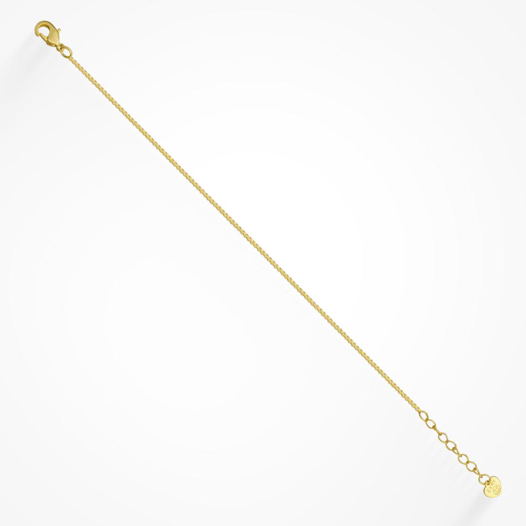 Fine gold colored box chain bracelet with a lobster clasp and small end tag on a white background