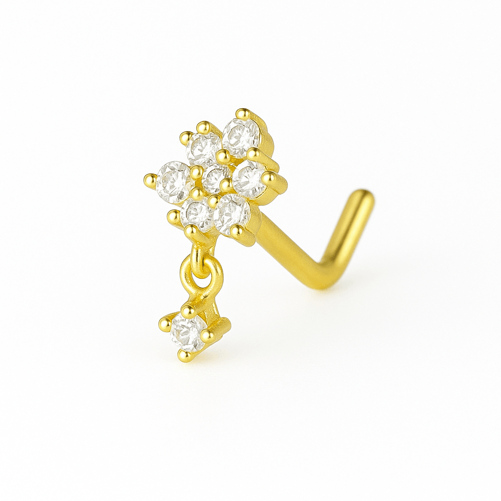Gold tone L shaped nose stud with a clear stone flower cluster and a small dangling clear stone on a white background