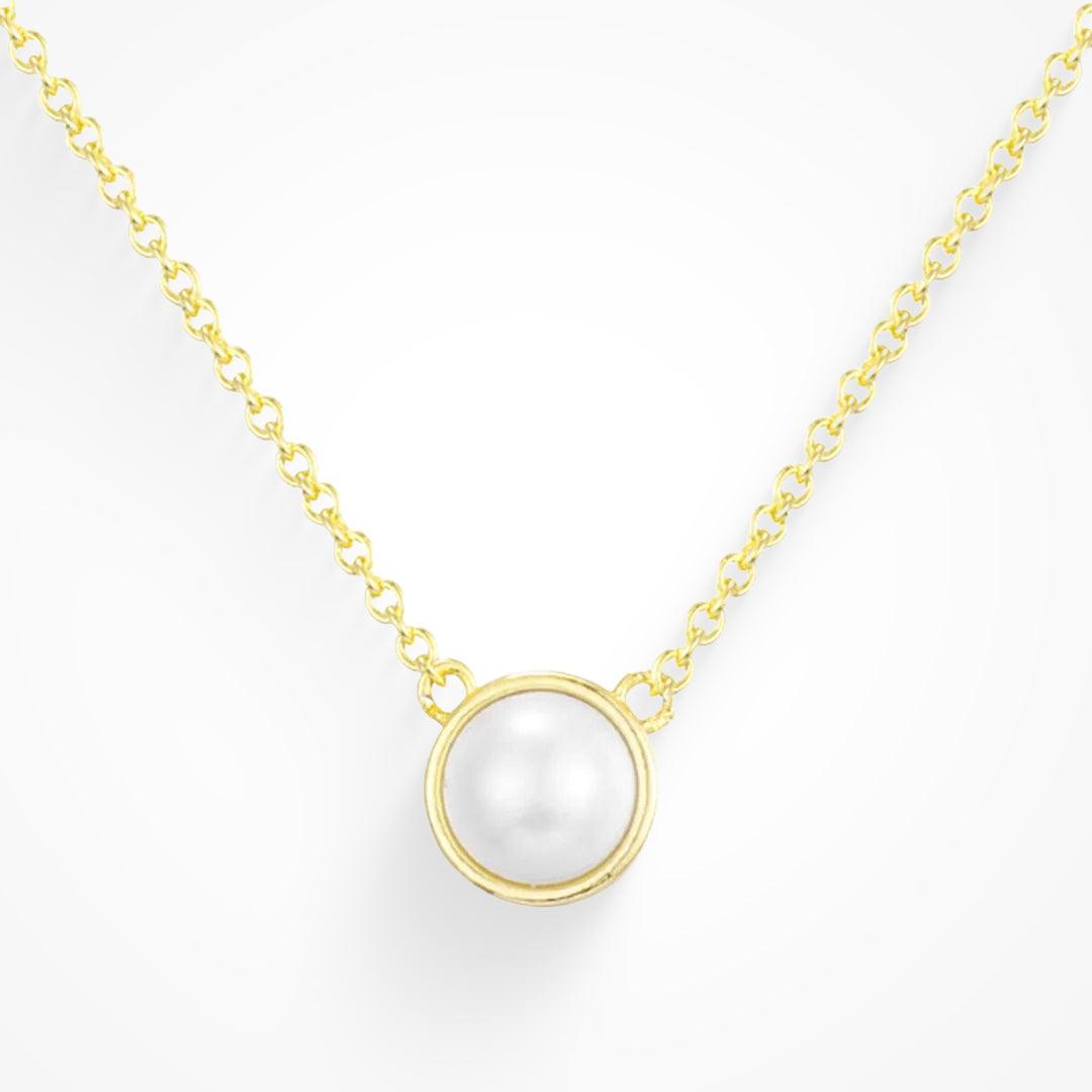 Gold tone chain necklace with a single round white pearl pendant in a bezel setting